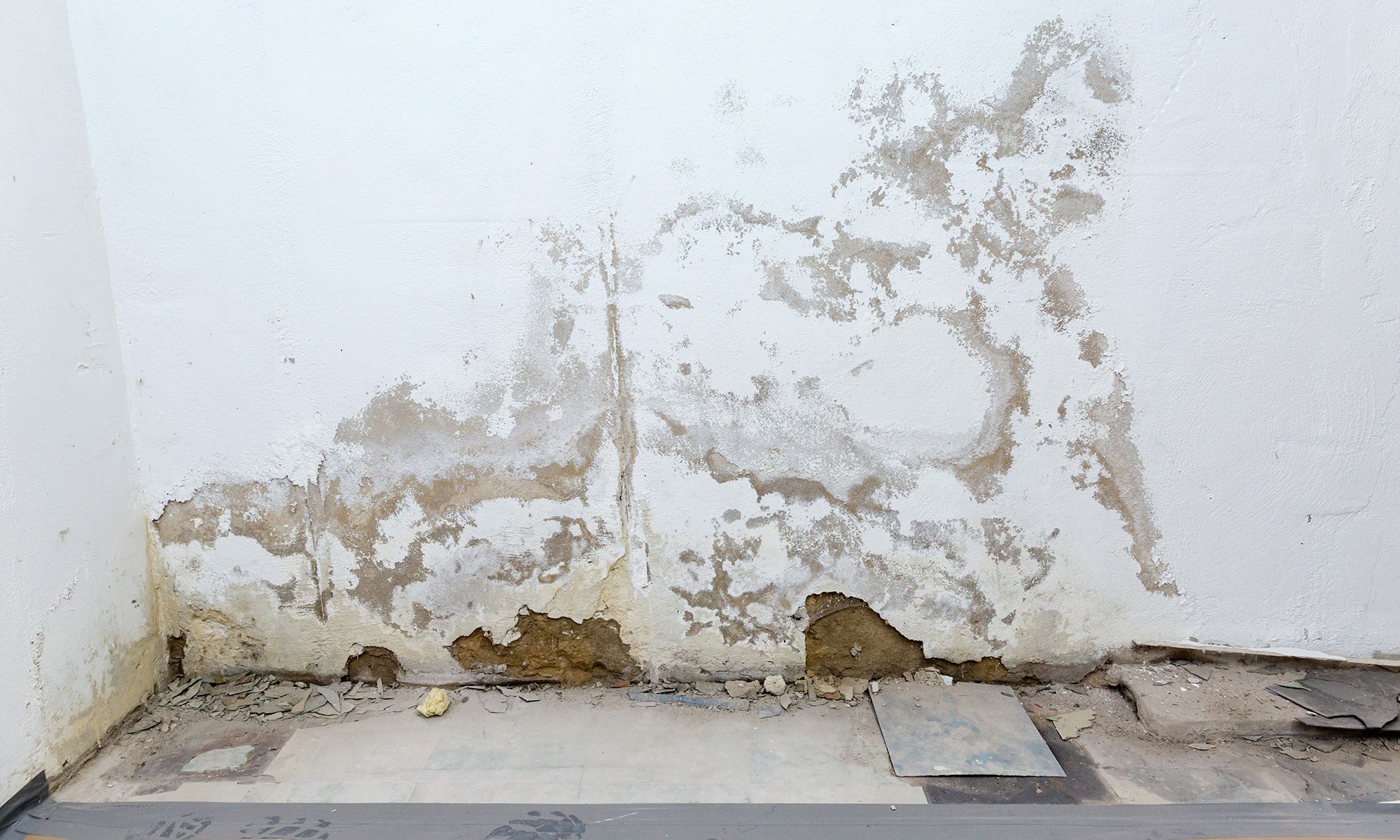 Wall with moisture marks and damaged surface